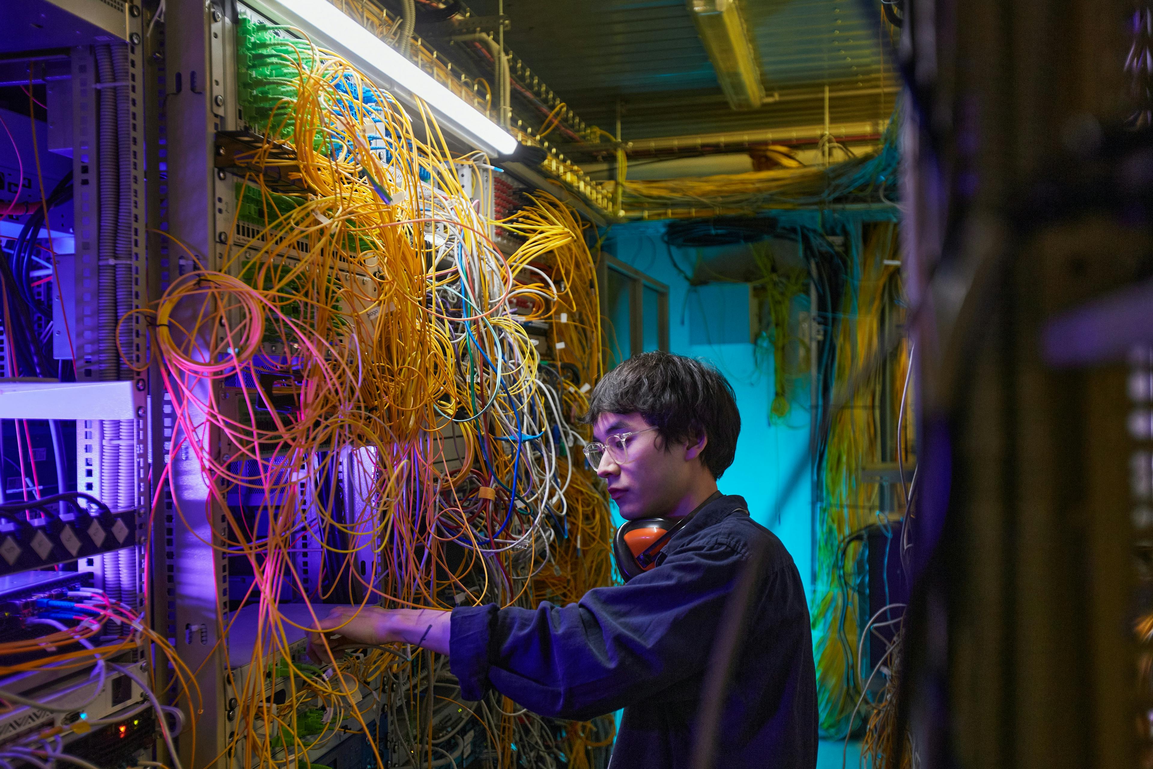 Engineer inspecting equipment in a computing server room