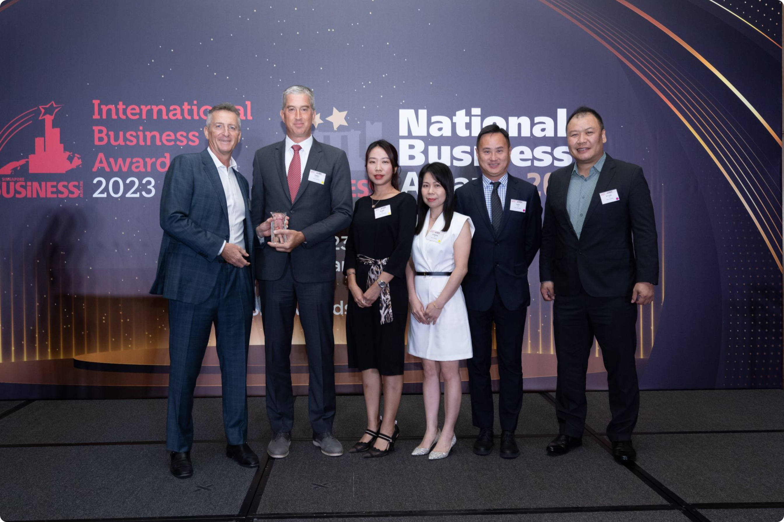 Group of Fusion Worldwide accepting an award at the 2023 International Business Awards