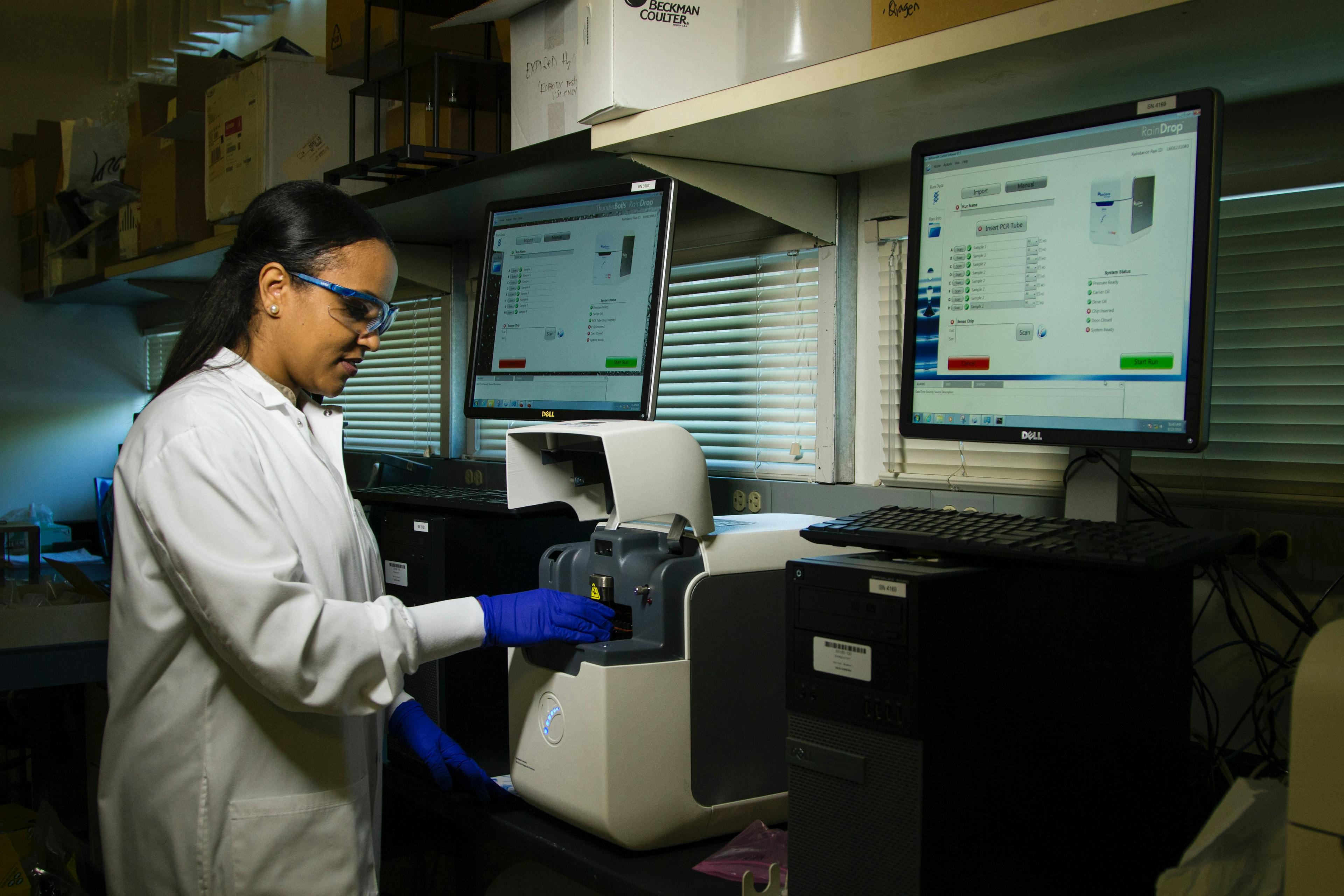 Technical employee inspecting samples at a healthcare lab
