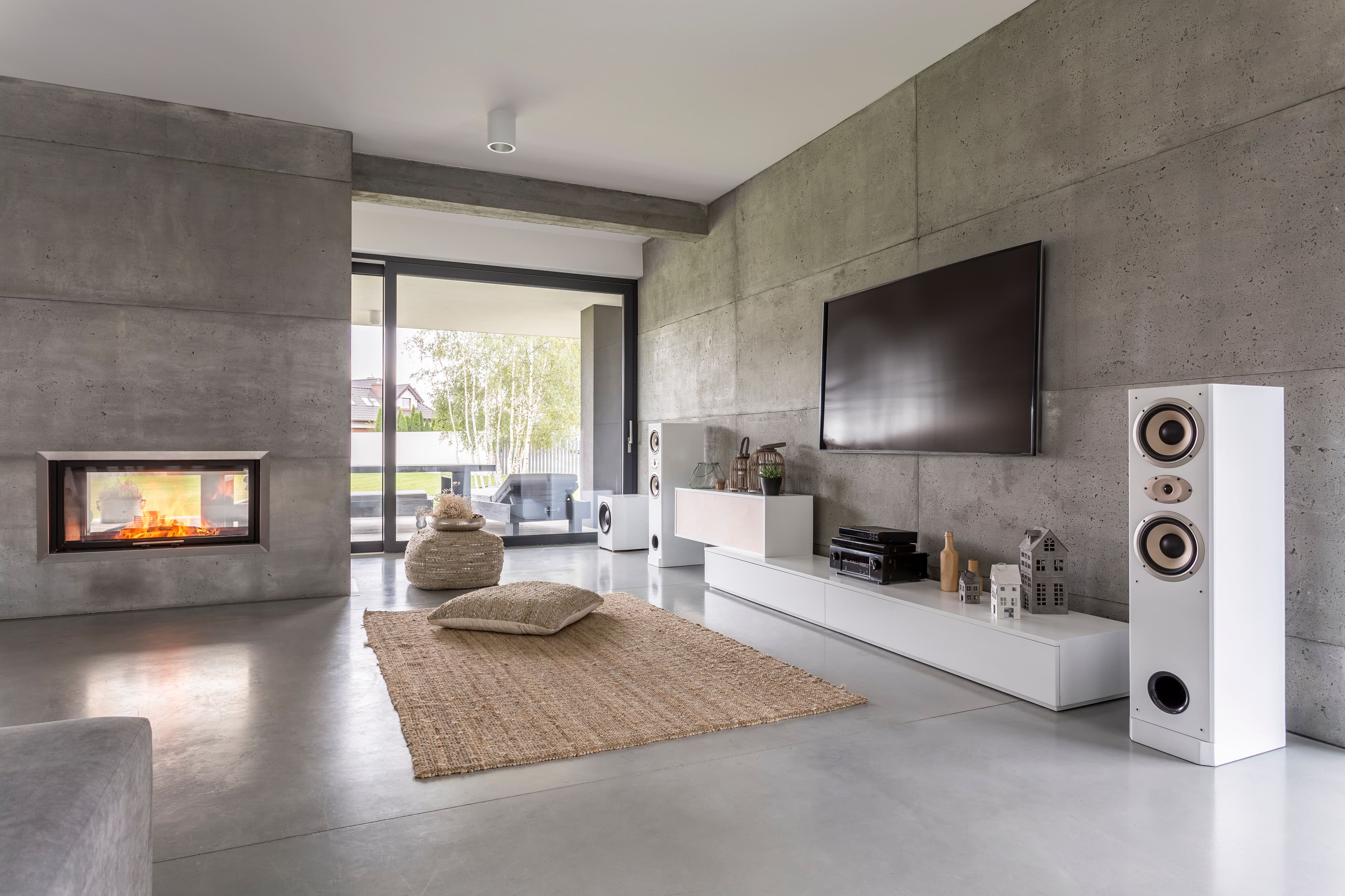 Living room with a TV, fireplace, and large speakers