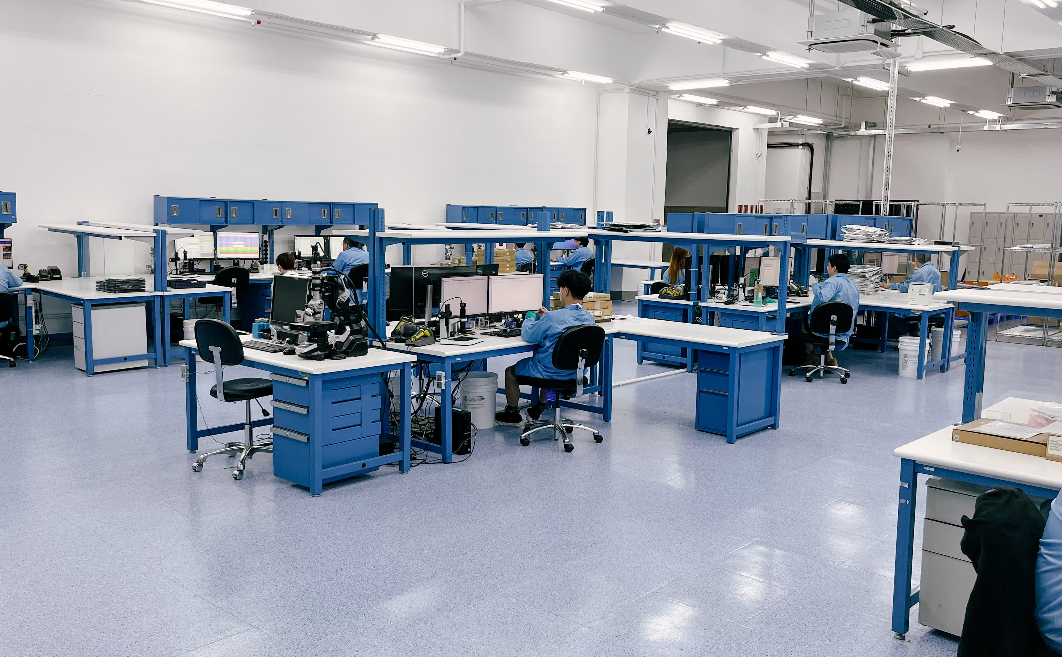 Group of engineers sitting at their desks in Fusion Worldwide's Hong Kong Quality Control Center